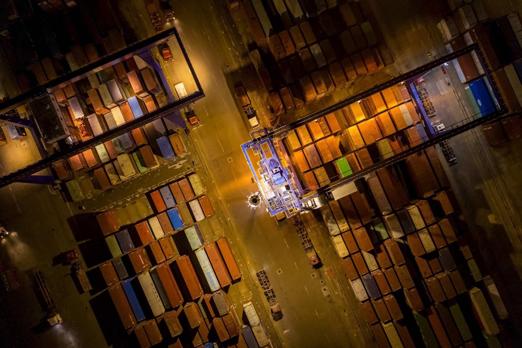 A wide aerial view of a busy Chinese shipping port used for shipping zinc chloride and other bulk cargo