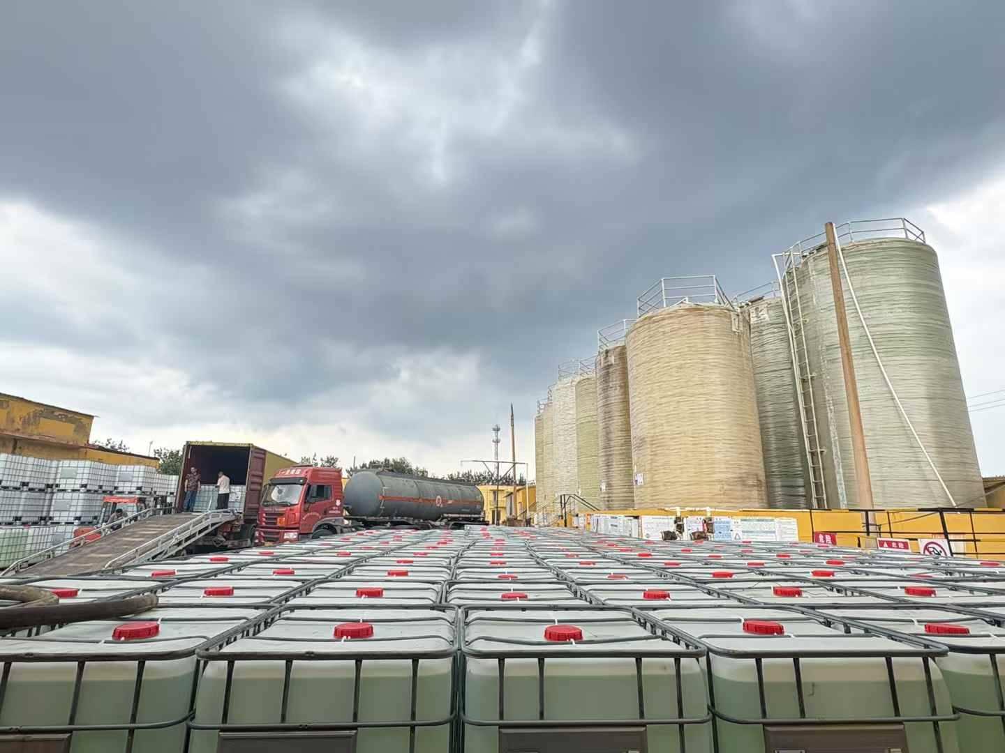 Industrial yard with storage tanks and tanker truck