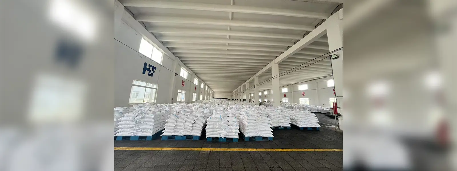 Warehouse storing bulk zinc chloride bags, ready for industrial supply