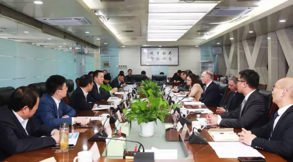 International business team in formal meeting discussing zinc chloride supply contract