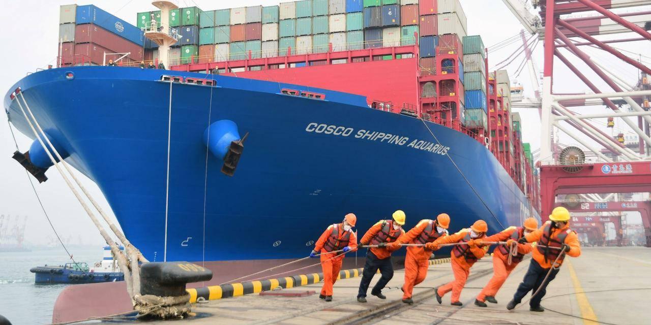Large cargo ship being loaded at a busy Chinese port