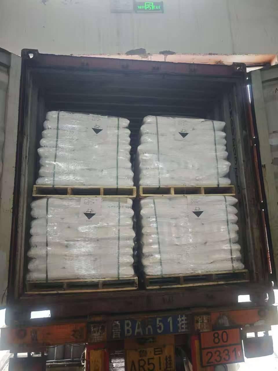 Stacked pallets of zinc chloride bags loaded in an export container