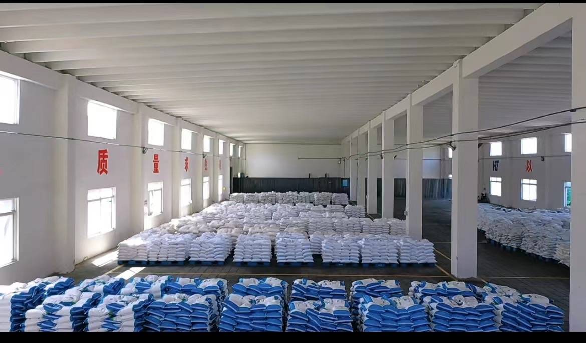 Large bags of zinc chloride stacked in a clean warehouse, ready for shipment.