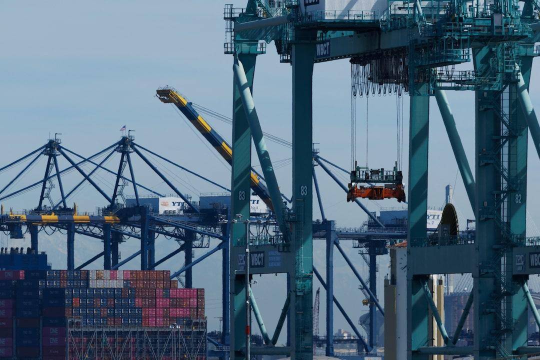 Faceless port workers overseeing the loading of chemical containers, highlighting bulk export capacity.