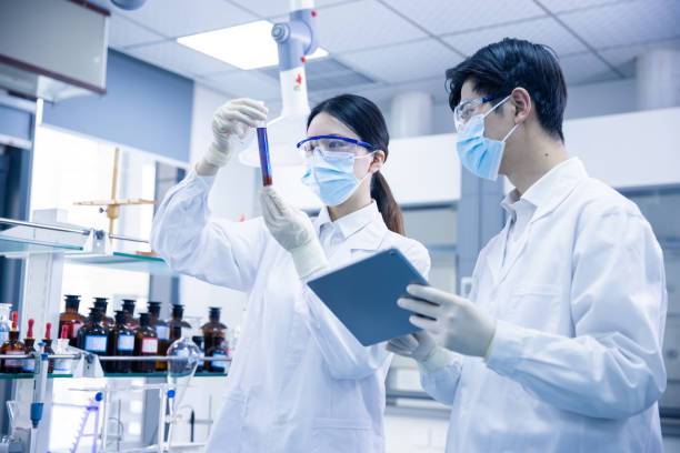 A faceless Asian scientist conducting rigorous quality tests in a modern chemical laboratory.