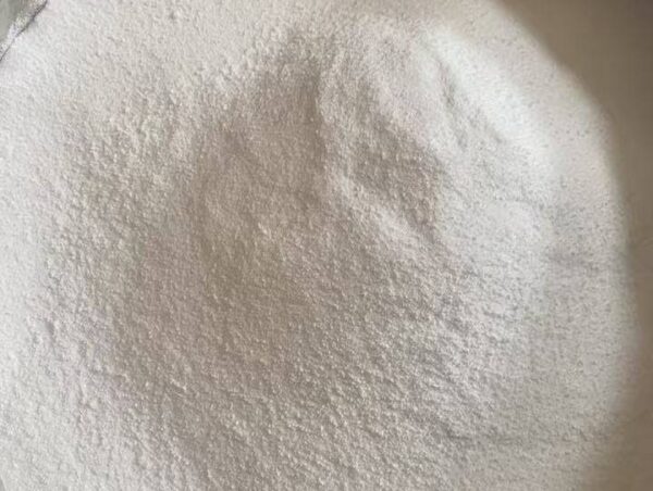 Close-up of high-purity white zinc chloride powder in a large industrial container
