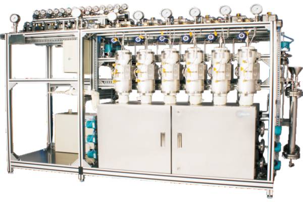 A faceless view of a complex industrial catalytic reactor system with multiple stainless steel tanks and piping.