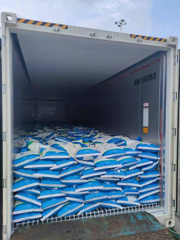 Zinc chloride chemical packaging being loaded for international shipping