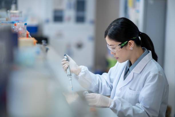 Female chemist performing a quality test with zinc chloride