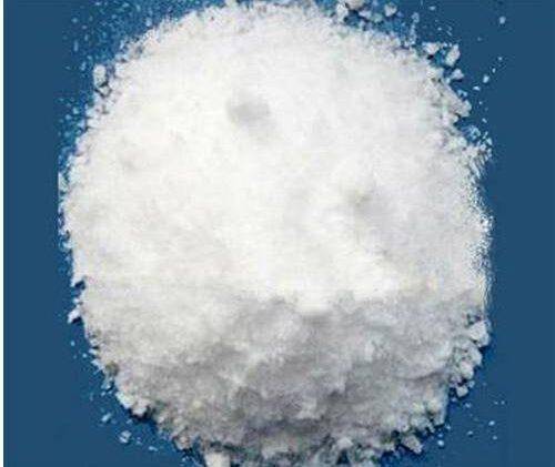 White zinc chloride powder in a circular pile on a blue background