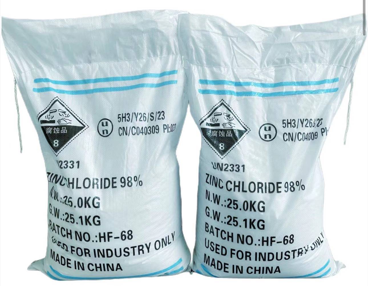 White 25kg sacks of 98% zinc chloride labeled with UN2331 hazard symbols, ready for export